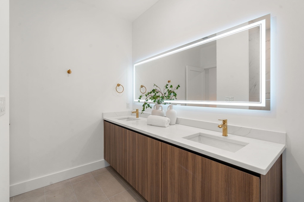 16 Stearns Road, Unit 101 Wellesley, MA 02482 - Photo 15 of 18 a bathroom with a sink and a mirror