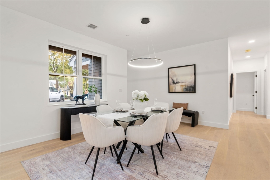 16 Stearns Road, Unit 101 Wellesley, MA 02482 - Photo 7 of 18 a dining room with furniture a rug and a painting