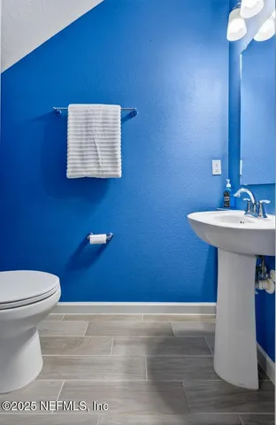 a kitchen with stainless steel appliances a table chairs and chandelier