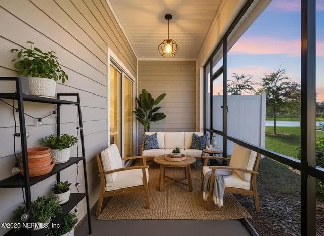 a spacious bedroom with a bed and a flat tv screen on dresser