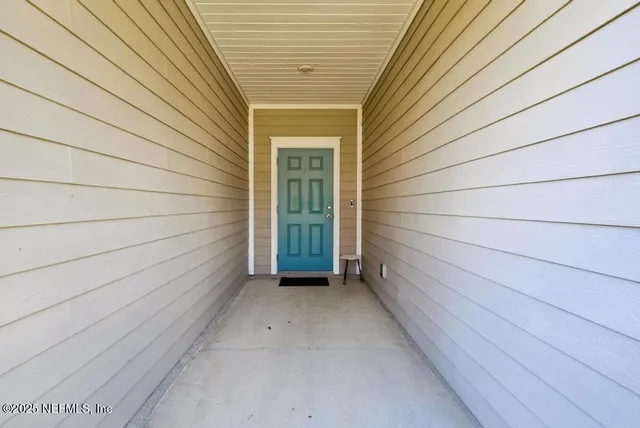 a view of a wooden door and wooden floor