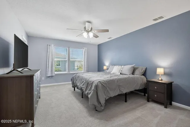 a bathroom with a sink toilet vanity and shower