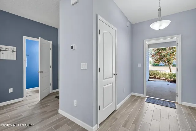 a view of hallway with wooden floor