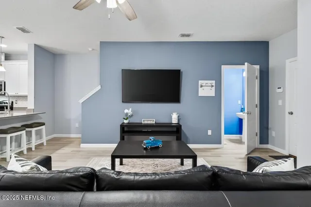 a living room with furniture a rug and a chandelier