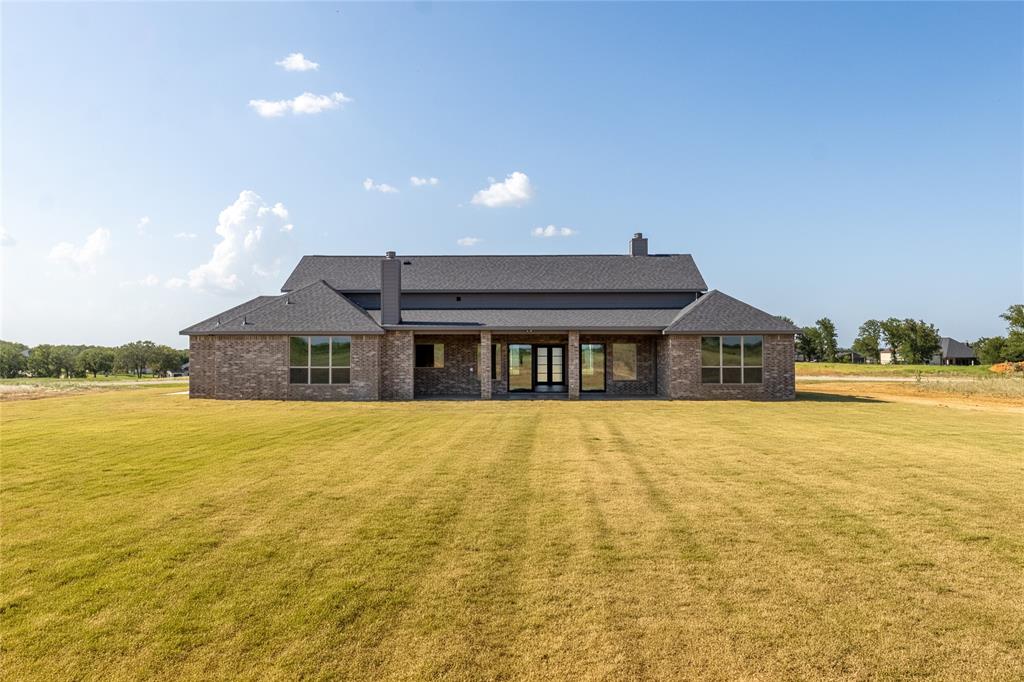 115 Red Bud Road Boyd, TX 76023 - Photo 38 of 38 Expansive backyard featuring a manicured lawn