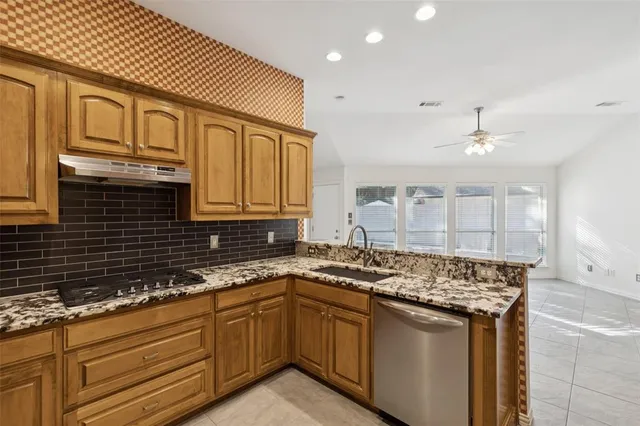 a kitchen with granite countertop a sink and cabinets
