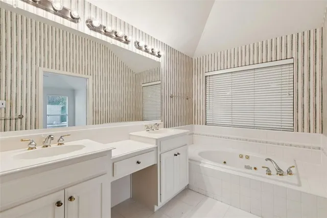 a bathroom with a bathtub a sink and a window