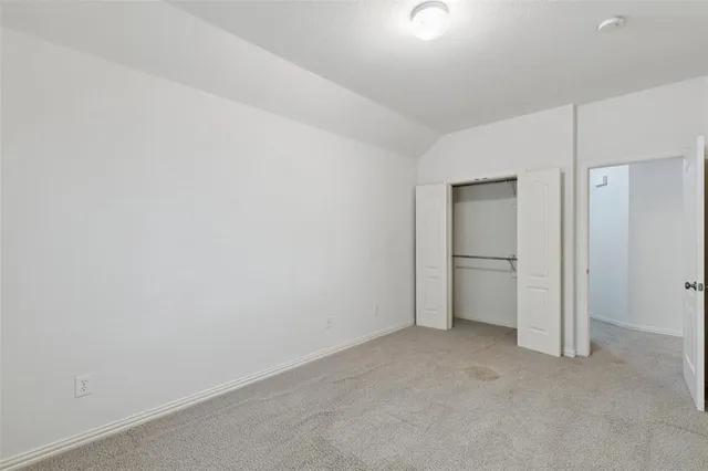 a view of an empty room and closet area