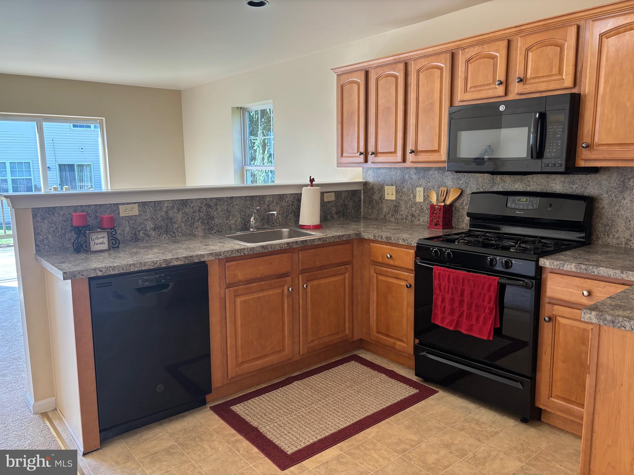 6846 Hunt Drive Macungie, PA 18062 - Photo 5 of 28 a kitchen with stainless steel appliances a stove sink microwave and cabinets