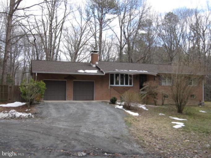 13240 Olivet Road Lusby, MD 20657 - Photo 1 of 24 a front view of a house with a yard