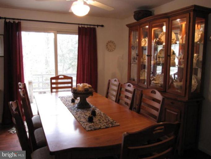 13240 Olivet Road Lusby, MD 20657 - Photo 2 of 24 a room with furniture and large windows