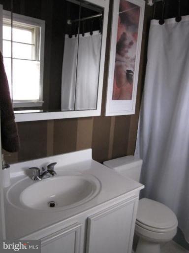 13240 Olivet Road Lusby, MD 20657 - Photo 11 of 24 a bathroom with a sink and a mirror