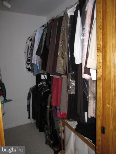 13240 Olivet Road Lusby, MD 20657 - Photo 12 of 24 a view of walk in closet with clothes and shoes