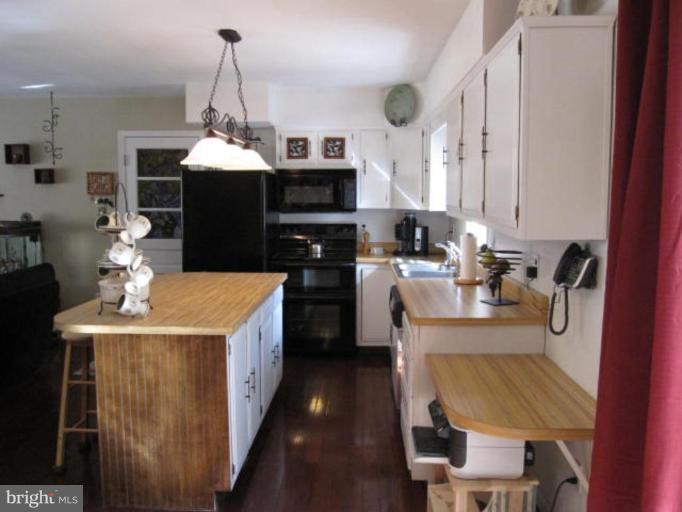 13240 Olivet Road Lusby, MD 20657 - Photo 5 of 24 a kitchen with a sink stove and microwave
