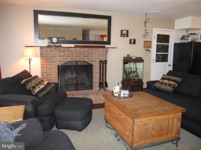 13240 Olivet Road Lusby, MD 20657 - Photo 6 of 24 a living room with furniture and a fireplace