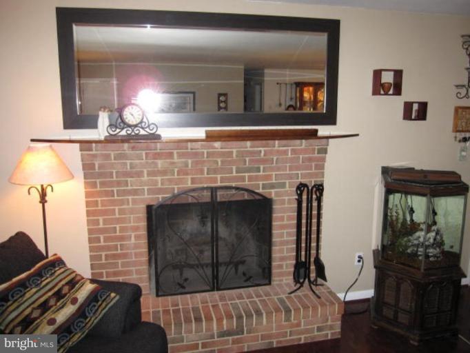 13240 Olivet Road Lusby, MD 20657 - Photo 7 of 24 a living room with furniture and a fireplace