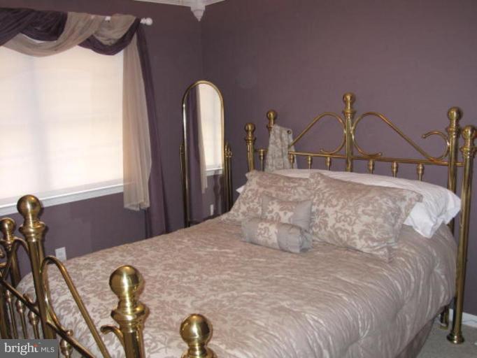 13240 Olivet Road Lusby, MD 20657 - Photo 8 of 24 a bedroom with a bed and dresser