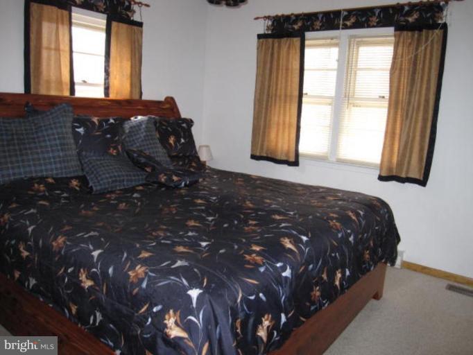 13240 Olivet Road Lusby, MD 20657 - Photo 10 of 24 a bedroom with a bed window and mirror