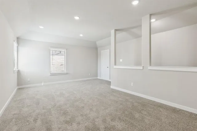 an empty room with windows and closet
