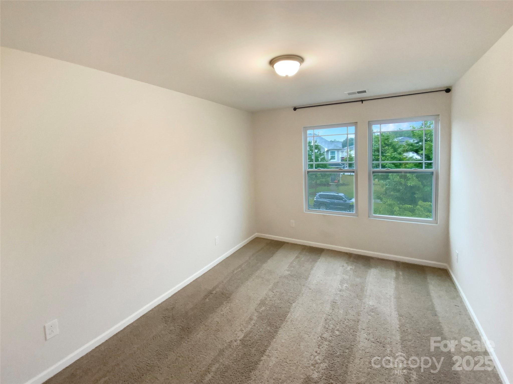 4105 Galloway Road Charlotte, NC 28262 - Photo 9 of 23 an empty room with wooden floor and windows