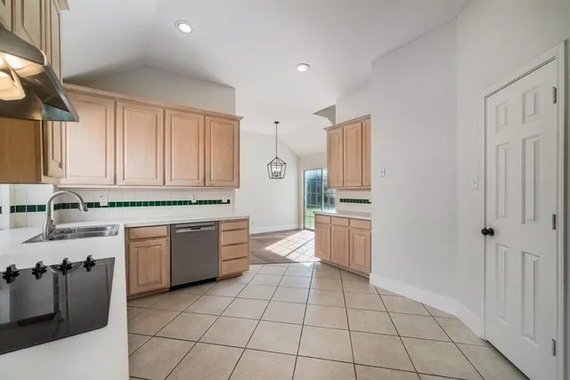 a kitchen with a sink a stove top oven and cabinets