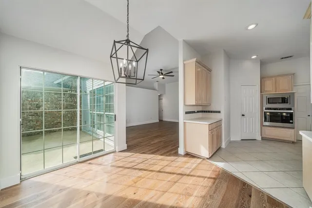a kitchen with stainless steel appliances kitchen island granite countertop a stove and cabinets