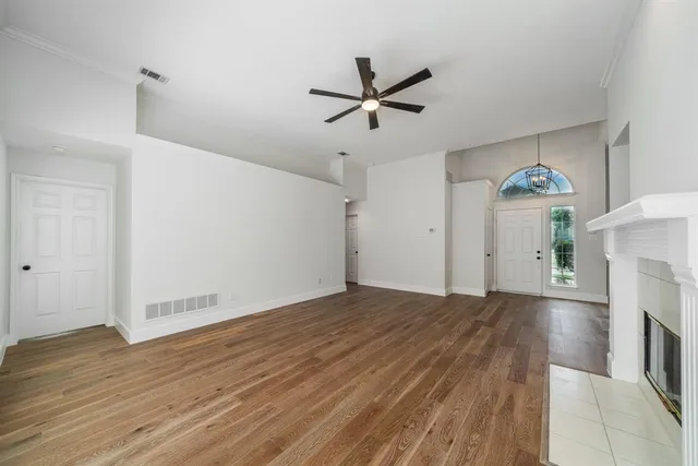 wooden floor in an empty room with a fireplace