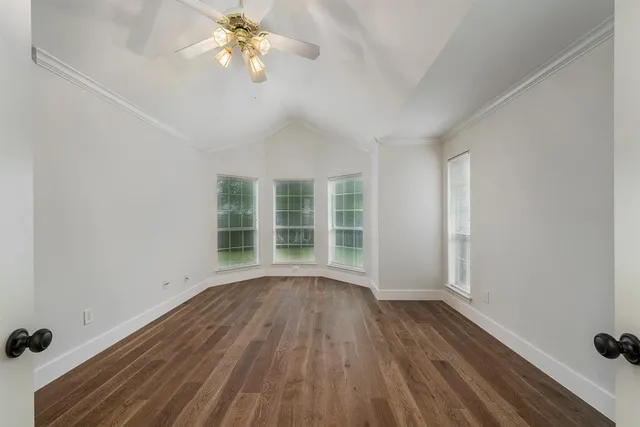 wooden floor in an empty room with a window