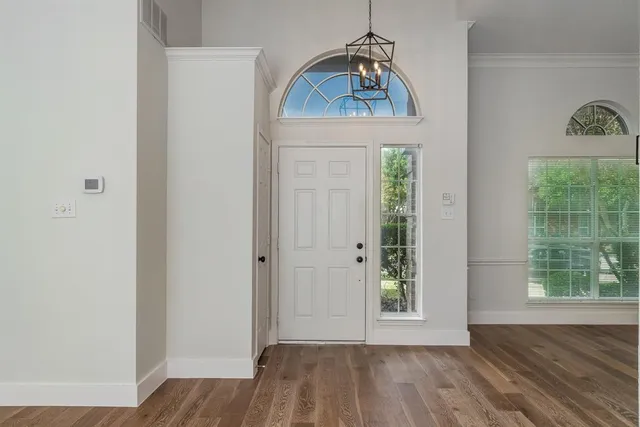 a view of hallway with wooden floor and window