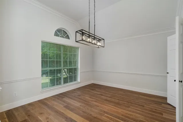 a view of a room with wooden floor and window