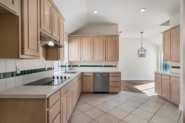 a kitchen with a sink stove and cabinets
