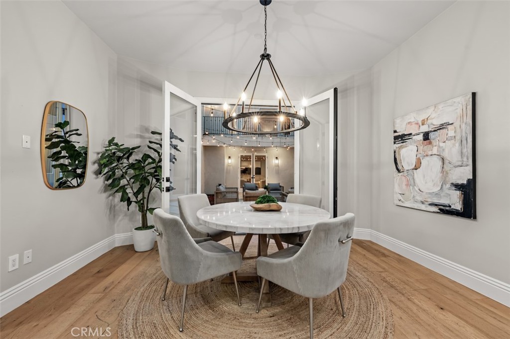 13248 Nightsky Drive Camarillo, CA 93012 - Photo 15 of 53 a dining room with wooden floor a chandelier a wooden table and chairs