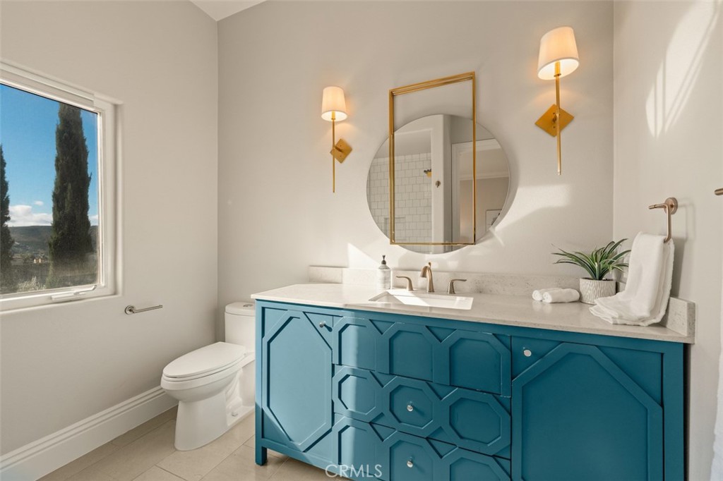 13248 Nightsky Drive Camarillo, CA 93012 - Photo 35 of 53 a bathroom with a toilet sink and mirror