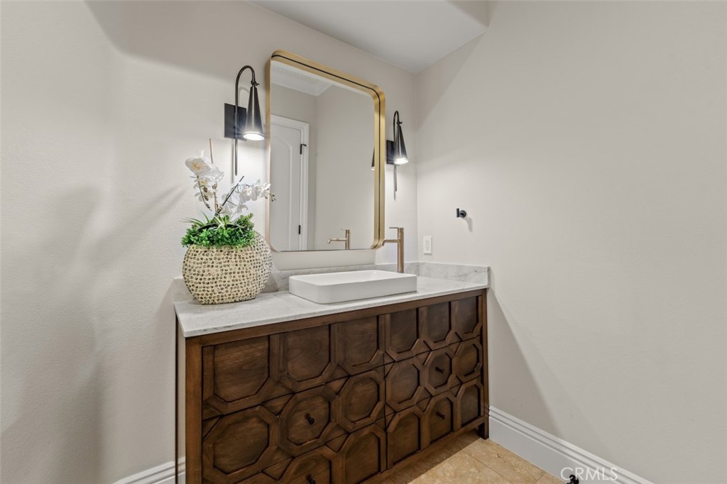 13248 Nightsky Drive Camarillo, CA 93012 - Photo 38 of 53 a bathroom with a granite countertop sink and a mirror