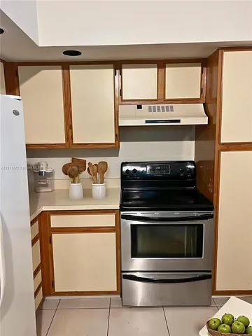 a stove top oven sitting inside of a kitchen