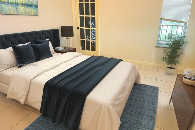 a bedroom with bed and window