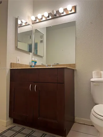 a bathroom with a sink a mirror and a toilet