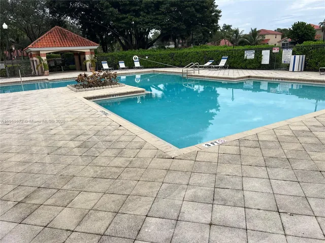a view of a swimming pool with lounge chair