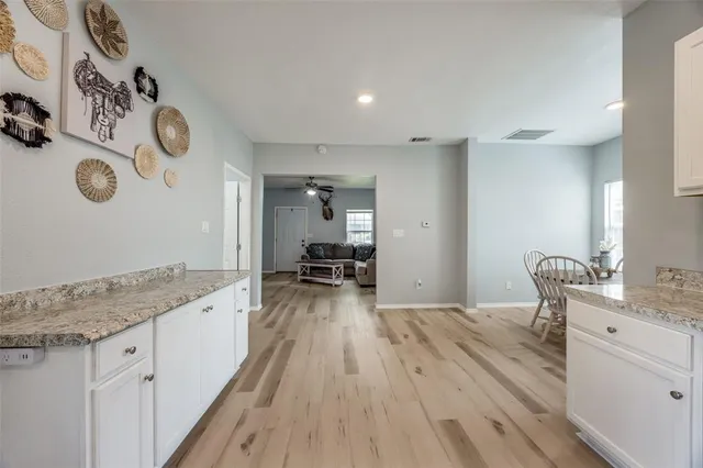 a spacious bathroom with a granite countertop sink and a mirror