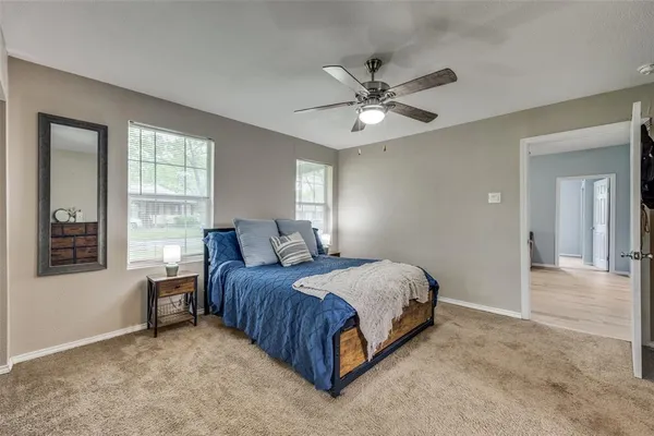 a spacious bedroom with a bed and window