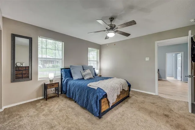 a spacious bedroom with a bed and window