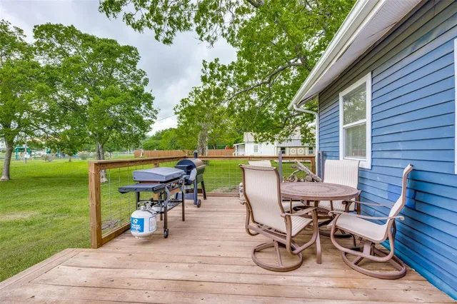 a view of a patio with a table and chairs