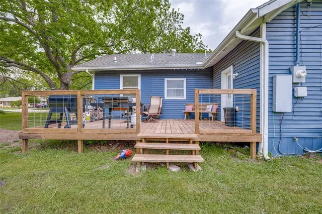 a front view of a house with swimming pool table and chairs