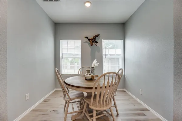a dining room with furniture and window