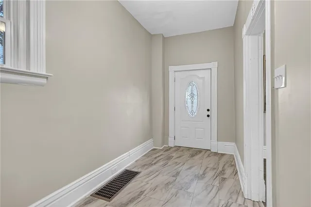 a view of hallway with wooden floor