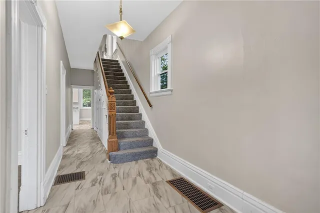 a view of entryway and hall with wooden floor