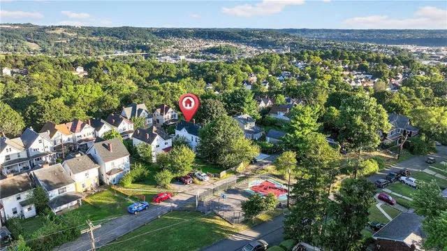 an aerial view of residential houses with outdoor space and street view