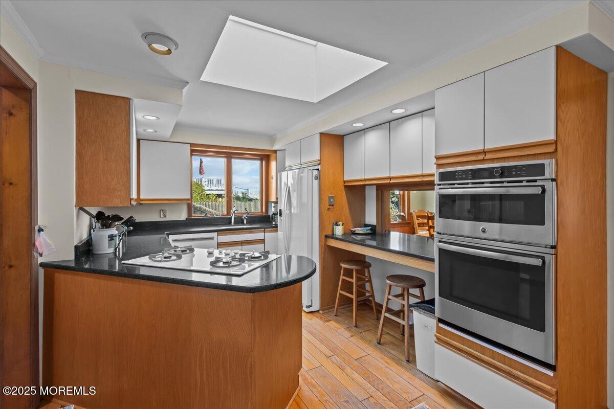 262 Sunset Lane Mantoloking, NJ 08738 - Photo 11 of 45 a kitchen with stainless steel appliances granite countertop a stove a sink and a refrigerator