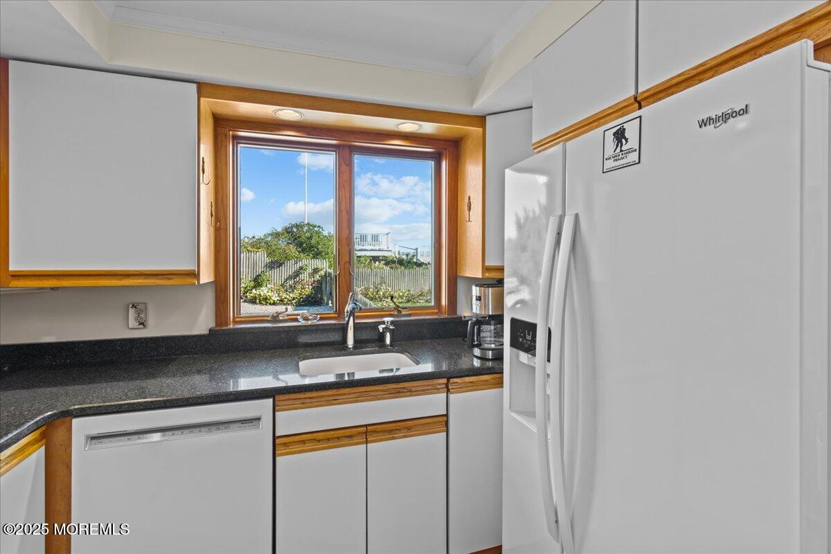 262 Sunset Lane Mantoloking, NJ 08738 - Photo 12 of 45 a kitchen with stainless steel appliances a sink and a window