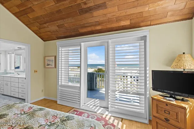 a bathroom with a sink a toilet and a large mirror